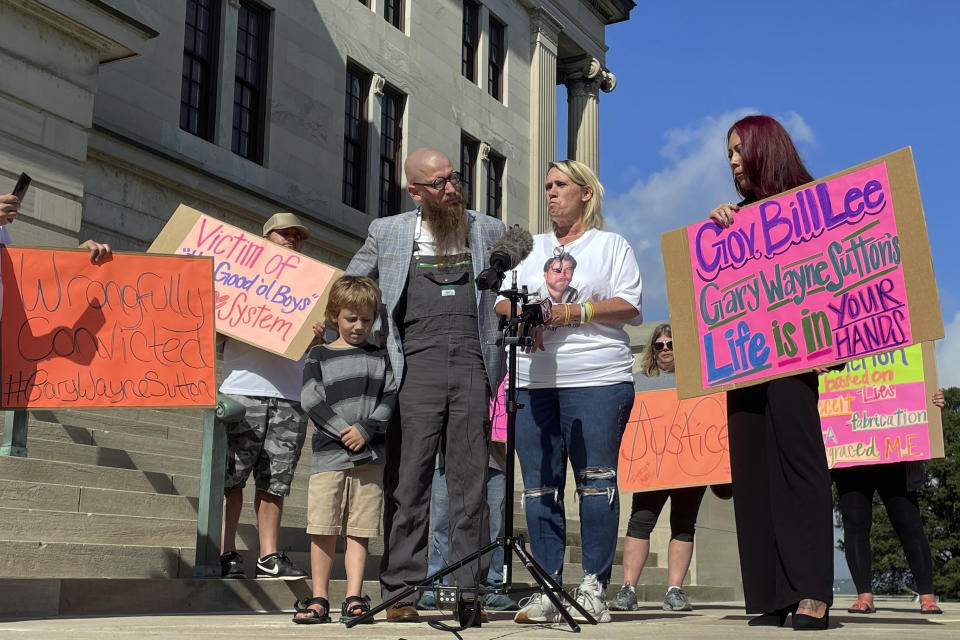 Carolyn Miller, center right, speaks at a news conference called by friends and family of Tennessee death row inmate Gary Sutton, Friday, Oct. 6, 2023, outside the Tennessee State Capitol in Nashville, Tenn. Sutton’s supporters want to publicize his effort to pursue a claim of innocence and have his public defender removed from his case. Miller was Sutton’s girlfriend in 1992 when Tommy Griffin and Griffin's s sister Connie Branam were murdered. Miller said in an interview that she knows Sutton is innocent in their deaths because he was with her the weekend that the siblings were killed. (AP Photo/Travis Loller)