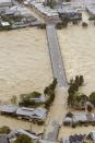 An aerial view shows the flooded Katsura river and the partially-submerged Togetsu bridge as tropical storm Man-yi, locally named Typhoon No.18, makes landfall in Kyoto, western Japan, in this photo taken by Kyodo September 16, 2013. Torrential rain hit western Japan on Monday morning as Man-yi made landfall in the country's central region, prompting the weather agency to warn of "unprecedented heavy rain" and urge people to take safety precautions. In Kyoto Prefecture, some 260,000 residents were ordered to evacuate, including about 81,000 in Fukuchiyama, Kyodo news reported. Mandatory Credit. REUTERS/Kyodo