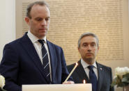 Francois-Philippe Champagne, Canada Minister of Foreign Affairs, right, UK's Secretary of State for Foreign Affair Dominic Raab light a candle in front of a plaque with the names of the victims of flight PS752, at the High Commission of Canada in London, Thursday, Jan. 16, 2020. The Foreign ministers gather in a meeting of the International Coordination and Response Group for the families of the victims of PS752 flight crashed shortly after taking off from the Iranian capital Tehran on Jan. 8, killing all 176 passengers and crew on board.(AP Photo/Frank Augstein)