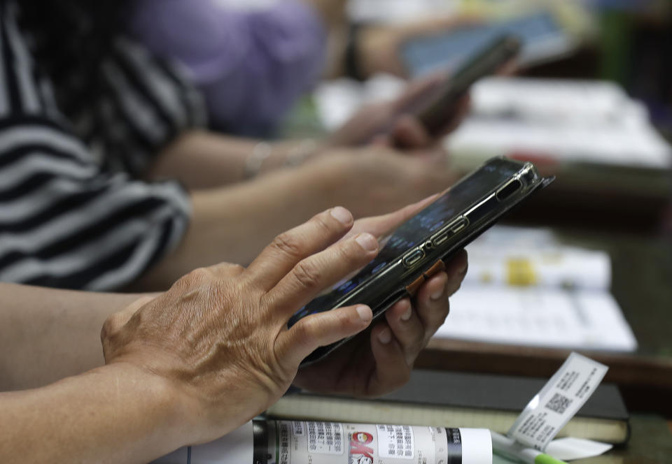 Students of Fake News Cleaner learn how to use the LINE app to identify fake news during a class in Kaohsiung City, southern Taiwan, Thursday, March 16, 2023. An anti-misinformation group in Taiwan called Fake News Cleaner has hosted more than 500 events, connecting with college students, elementary-school children — and the seniors that, some say, are the most vulnerable to such efforts. (AP Photo/Chiang Ying-ying)