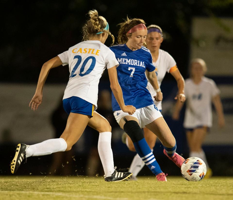 Memorial’s Avarie Zeller (7) dribbles the ball around Castle’s Izzie Ryan (20) as the Memorial Tigers play the Castle Knights at Memorial High School in Evansville, Ind., Tuesday evening, Sept. 13, 2022.