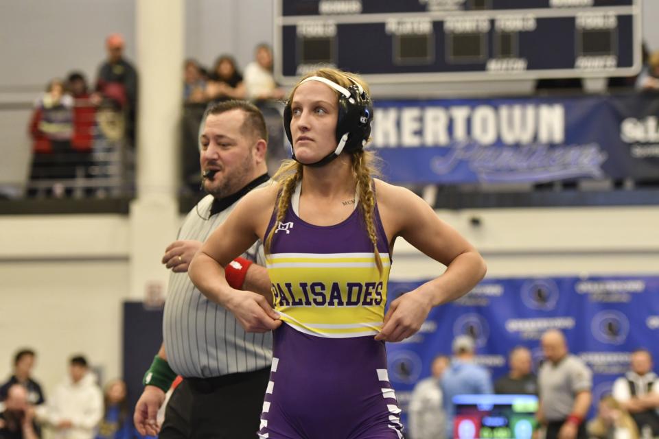 Palisades High School wrestler Savannah Witt, foreground, prepares for semifinal match during the Southeast Regional wrestling tournament Sunday, Feb. 25, 2024, in Quakertown, Pa. Girls’ wrestling has become the fastest-growing high school sport in the country. (AP Photo/Marc Levy)