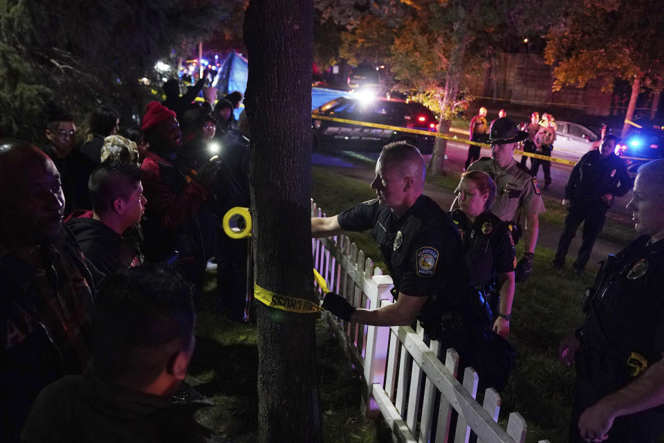 Police put up tape in an area near an officer involved shooting on East 77th Street in Richfield, Minn., Saturday night, Sept. 7, 2019. Police near Minneapolis shot and killed a driver following a chase after he apparently emerged from his car holding a knife and refused their commands to drop it. The chase started late Saturday night in Edina and ended in Richfield with officers shooting the man, Brian J. Quinones, who had streamed himself live on Facebook during the chase. (Anthony Souffle/Star Tribune via AP)