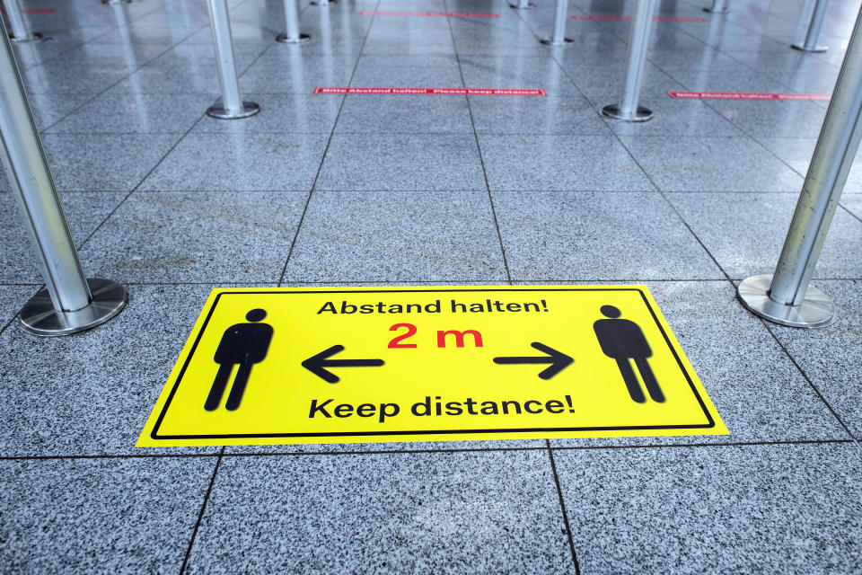 25 March 2020, North Rhine-Westphalia, Duesseldorf: "Keep your distance!" is written on stickers on the floor of the departure lounge at the airport. Air traffic is being severely disrupted by the coronavirus crisis. Photo: Federico Gambarini/dpa (Photo by Federico Gambarini/picture alliance via Getty Images)