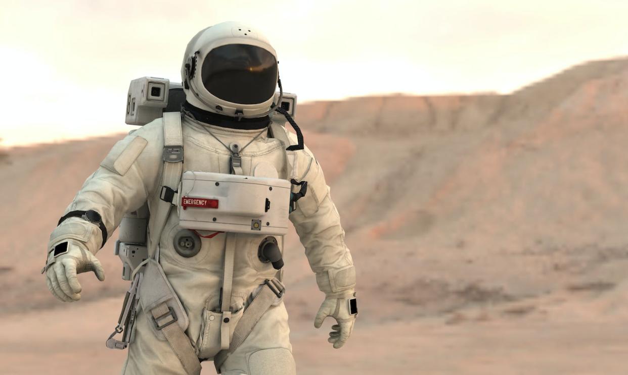 An artist's concept of an astronaut walking on Mars. But what would happen if the astronaut weren't wearing a space helmet? <a href="https://www.gettyimages.com/detail/photo/astronaut-walking-on-mars-royalty-free-image/1276723596?adppopup=true" rel="nofollow noopener" target="_blank" data-ylk="slk:cokada/E+ via Getty Images;elm:context_link;itc:0;sec:content-canvas" class="link ">cokada/E+ via Getty Images</a>