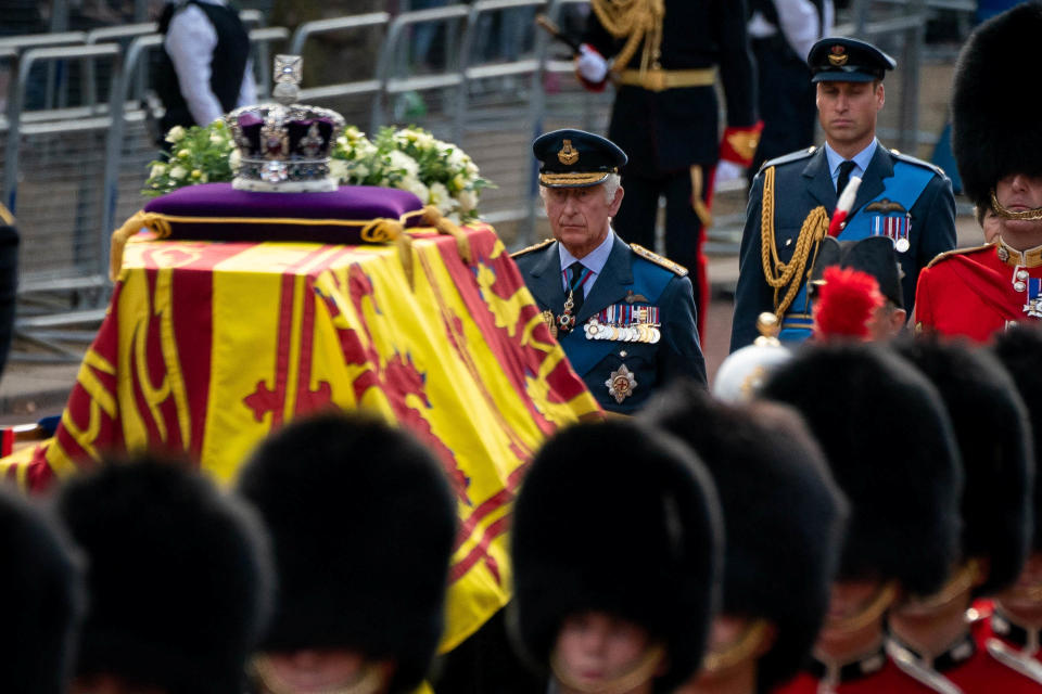 King Charles III and the Prince of Wales follow the coffin of Queen Elizabeth II, draped in the Royal Standard with the Imperial State Crown placed on top, carried on a horse-drawn gun carriage of the King's Troop Royal Horse Artillery, during the ceremonial procession from Buckingham Palace to Westminster Hall, London, where it will lie in state ahead of her funeral on Monday. Picture date: Wednesday September 14, 2022.  Aaron Chown/Pool via REUTERS