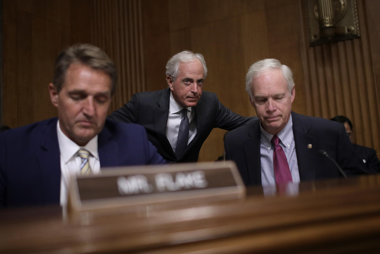 Sen. Bob Corker (R-Tenn.), center, chairman of the Senate Foreign Relations Committee, confers with Sen. Ron Johnson (R-Wis.), right, during a committee hearing&nbsp;Nov. 14&nbsp;in Washington, D.C. Also pictured is Sen. Jeff Flake (R-Ariz.). (Photo: Win McNamee via Getty Images)