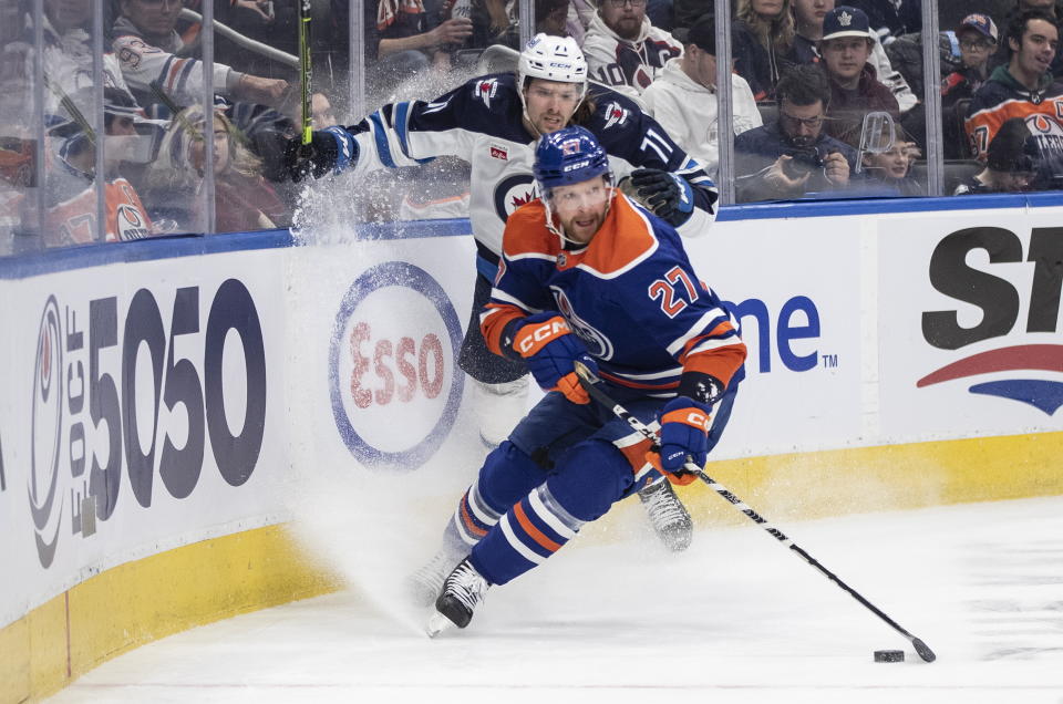 Winnipeg Jets' Axel Jonsson-Fjallby (71) defends against Edmonton Oilers' Brett Kulak (27) during the first period of an NHL hockey game Friday, March 3, 2023, in Edmonton, Alberta. (Jason Franson/The Canadian Press via AP)