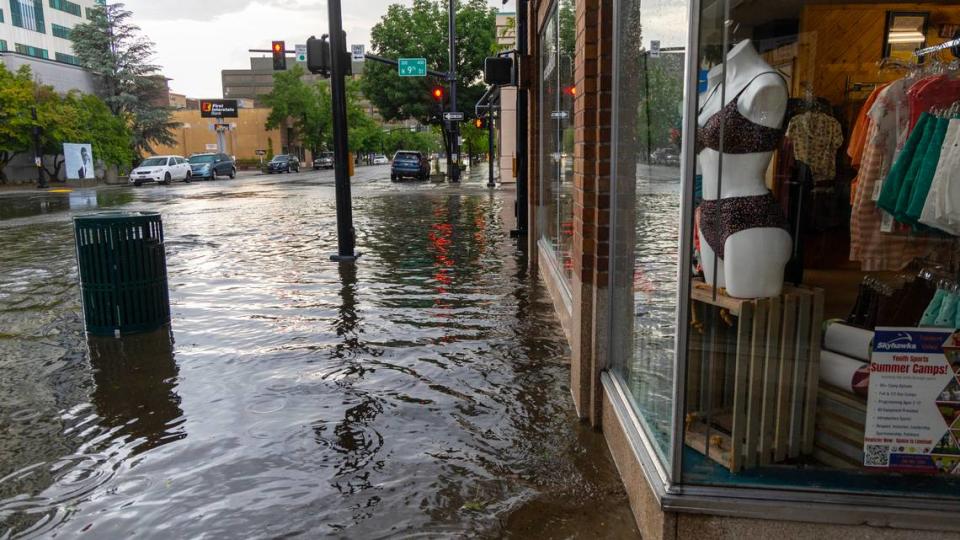 Water pools in front of businesses in downtown Boise during a flash thunderstorm that dropped up to 1.5 inches of rain in less than 90 minutes in parts of downtown. Hail was also reported.