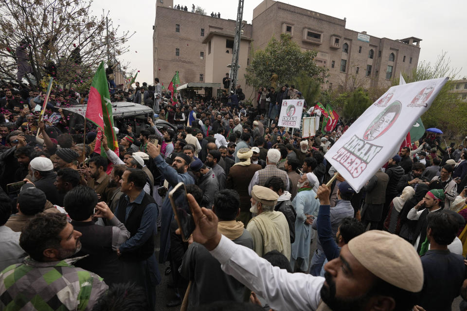 Supporters of former Pakistani Prime Minister Imran Khan gather outside a court, where their leader Khan appeared, in Islamabad, Pakistan, Tuesday, Feb. 28, 2023. A Pakistani court approved bail for Khan after he appeared before a judge in Islamabad amid tight security, officials said, months after police filed terrorism charges against the country's popular opposition leader for inciting people to violence. (AP Photo/Anjum Naveed)