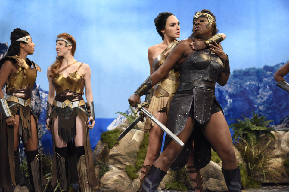 This image released by NBC shows Gal Gadot, center, and Leslie Jones, right during a sketch on "Saturday Night Live." Jones is leaving the NBC show after five seasons. Earlier this month, Jones announced she's doing a Netflix stand-up special. In an appearance on Jimmy Kimmel's show, Jones said it's great to be an actress but that she's really a "hardcore" stand-up comedian. (Will Heath/NBC via AP)