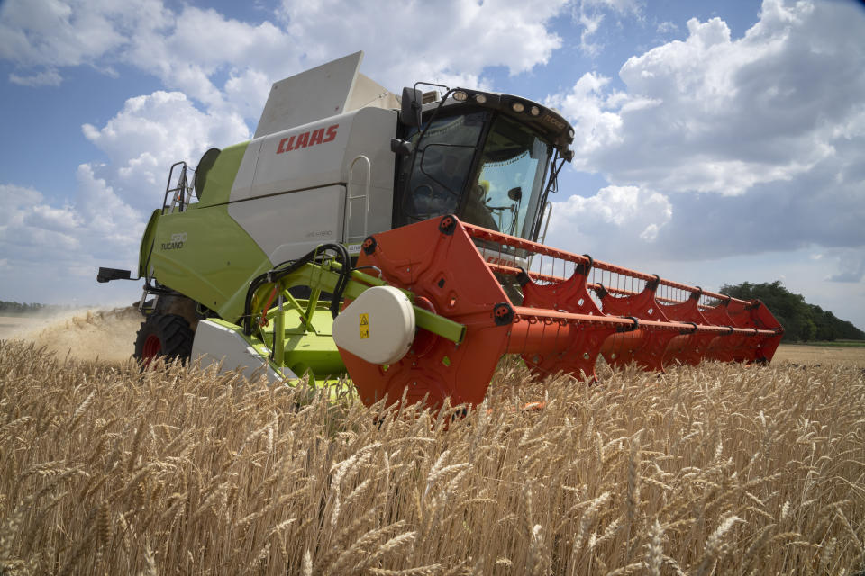 A farmer collects harvest on his field ten kilometres from the front line where fierce battle is going between Ukrainian troops and Russian invaders in the Dnipropetrovsk region, Ukraine, Monday, July 4, 2022. An estimated 22 million tons of grain are blocked in Ukraine, and pressure is growing as the new harvest begins. The country usually delivers about 30% of its grain to Europe, 30% to North Africa and 40% to Asia. But with the ongoing Russian naval blockade of Ukrainian Black Sea ports, millions of tons of last year’s harvest still can’t reach their destinations. (AP Photo/Efrem Lukatsky)