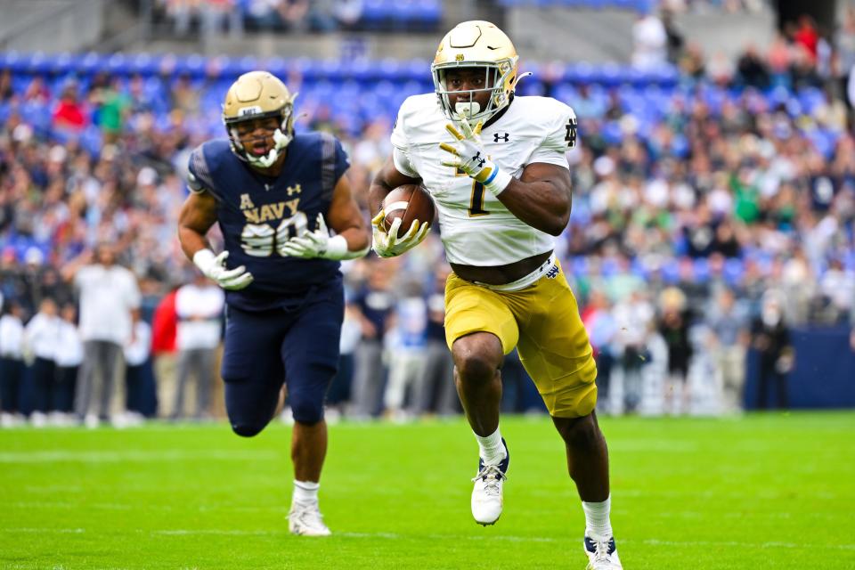 Notre Dame running back Audric Estime (7) runs the ball for a touchdown during the first half of an NCAA college football game against Navy , Saturday, Nov. 12, 2022, in Baltimore. (AP Photo/Terrance Williams)