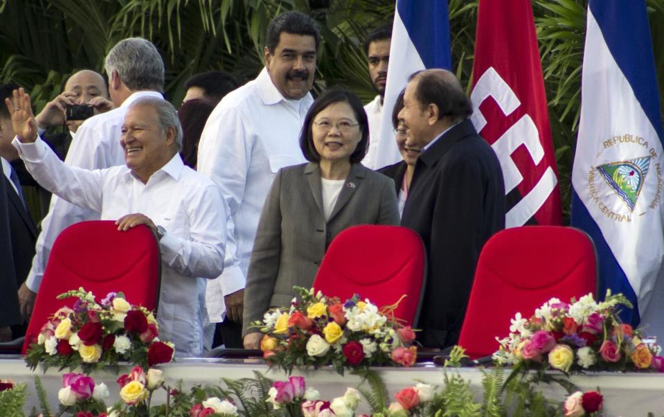 Nicaragua's President Daniel Ortega, right, welcomes Taiwan's President Tsai Ing-wen, center, at the start of his swearing-in ceremony in Managua, Nicaragua, Tuesday, Jan. 10, 2017. Also attending are El Salvador President Salvador Sanchez Ceren, left, and Venezuela's President Nicolas Maduro, behind center. The Taiwanese leader is in Nicaragua as part of a weeklong state tour to reinforce Taiwanese relations in Central America. (AP Photo/Miguel Alvarez)