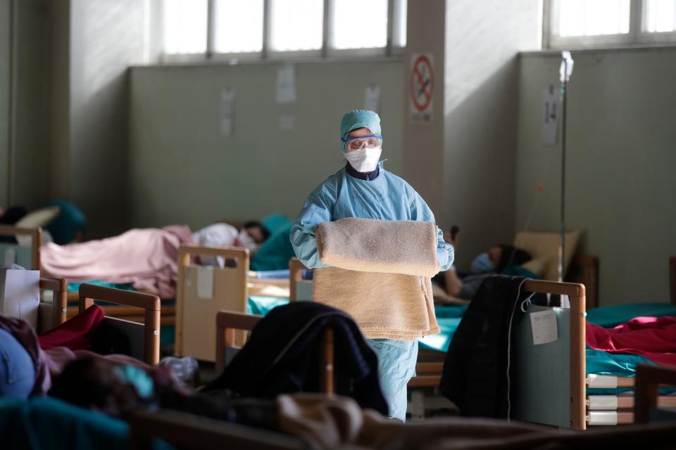 Medical staff work at one of the emergency structures that were set up to ease procedures at the Brescia hospital in northern Italy, March 16, 2020.