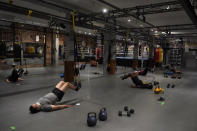 People wear masks while working out in social distancing spaces in an indoor class at a Hit Fit SF gym amid the coronavirus outbreak in San Francisco, Tuesday, Nov. 24, 2020. (AP Photo/Jeff Chiu)