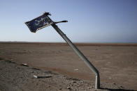 <p>In this Feb. 12, 2018 photo, shows a damaged sign in Arabic that reads, “Yemen,” on the road from Aden to Mocha in Yemen. (Photo: Nariman El-Mofty/AP) </p>