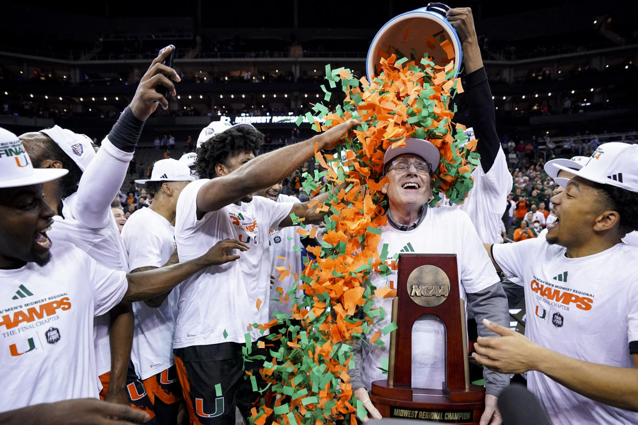 Miami basketball players dump confetti on head coach Jim Larrañaga as they celebrate defeating Texas on Sunday in Kansas City to advance to the Final Four. (Jay Biggerstaff-USA TODAY Sports)