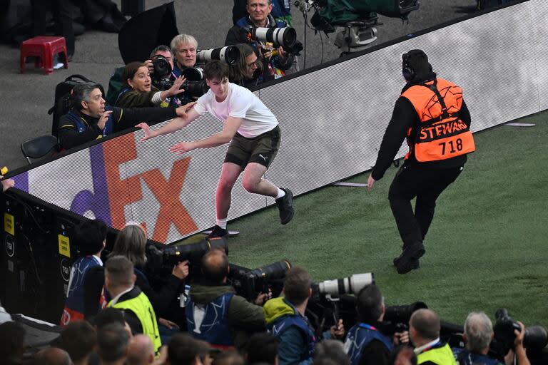 A pitch invader runs on the pitch during the UEFA Champions League final football match between Borussia Dortmund and Real Madrid, at Wembley stadium, in London, on June 1, 2024. (Photo by JUSTIN TALLIS / AFP)