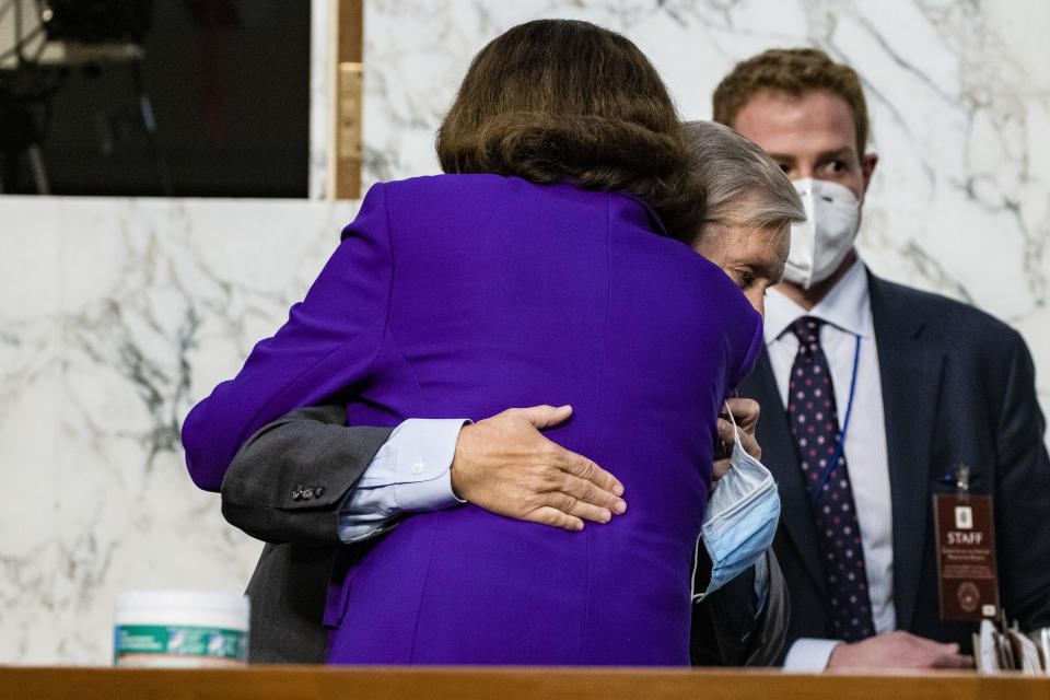 Sen. Dianne Feinstein (D-Calif.) hugs Sen. Lindsey Graham (R-S.C.) as the confirmation hearings for Supreme Court nominee Judge Amy Coney Barrett come to a close on Thursday. Neither senator wore a mask. (Photo: Samuel Corum via Getty Images)