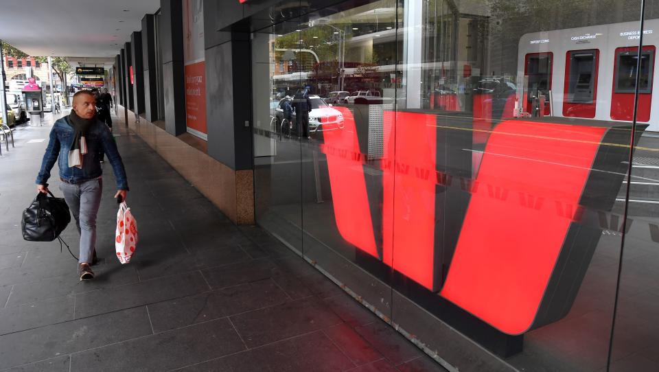 A man walks past a Westpac bank sign in Melbourne's central business district on May 4, 2020. - Westpac on May 4 announced its half-year net profit had fallen 62 percent, making it the latest Australian bank to see profits dive during the coronavirus crisis. (Photo by William WEST / AFP) (Photo by WILLIAM WEST/AFP via Getty Images)