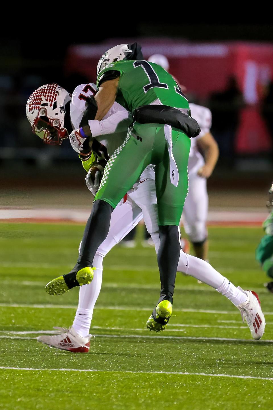 Badin's Braedyn Moore (11) attempts to take down Tippecanoe's Stanley Clyne (17) during the DIII regional final at Trotwood Madison High School Nov. 18, 2022.