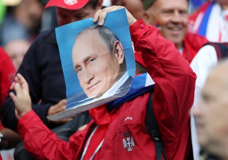 Soccer Football - World Cup - Group E - Serbia vs Switzerland - Kaliningrad Stadium, Kaliningrad, Russia - June 22, 2018 Serbia fan holds up a photo of Russian president Vladimir Putin before the match REUTERS/Mariana Bazo/Files