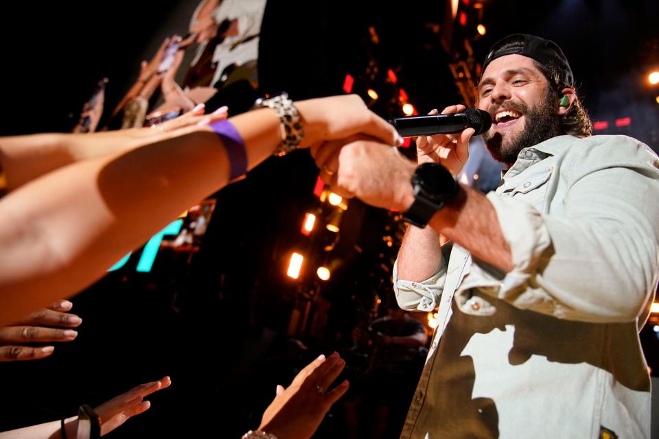 Thomas Rhett interacts with fans as he performs during CMA Fest in 2022.