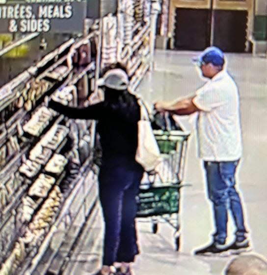 Surveillance photo from July 28 in Athens shows woman being distracted while a thief has his hand in the woman's purse.