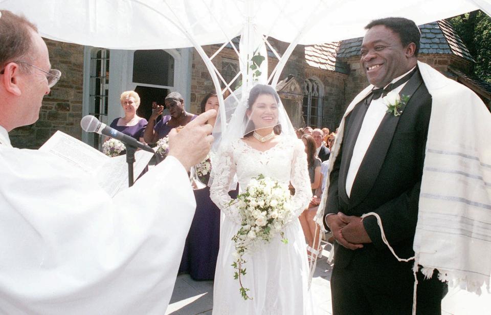 Rabbi Joel Braude, left, makes a toast during the wedding ceremony for actor Yaphet Kotto, right, and his bride Tessie Sinahon in Baltimore, Md., Sunday, July, 12, 1998. Kotto plays the imposing Lt. Al Giardello pn NBC's police drama 