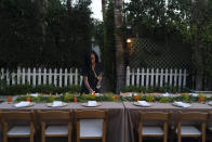 Osayi Endolyn, an inaugural artist-in-residence for the Black Lives Matter Global Network Foundation's Black Joy Creators Fellowship, helps set tables for a welcome dinner for the annual Families United 4 Justice Network Conference, hosted by the foundation at its mansion in the Studio City neighborhood of Los Angeles, Thursday, Sept. 28, 2023. (AP Photo/Jae C. Hong)