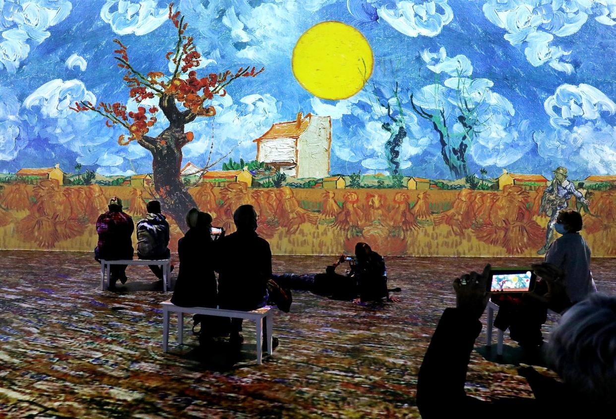 Visitors to the "Immersive Van Gogh Columbus Exhibit" take in all of the sights and sounds.