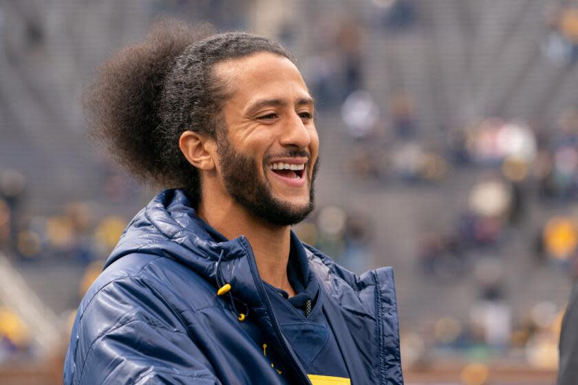 ANN ARBOR, MI - APRIL 02: Colin Kaepernick interacts with fans before the Michigan spring football game at Michigan Stadium on April 2, 2022 in Ann Arbor, Michigan. Kaepernick was honorary captain for the game. (Photo by Jaime Crawford/Getty Images)