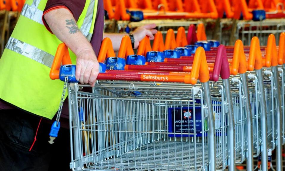 Sainsbury’s worker with shopping trolleys