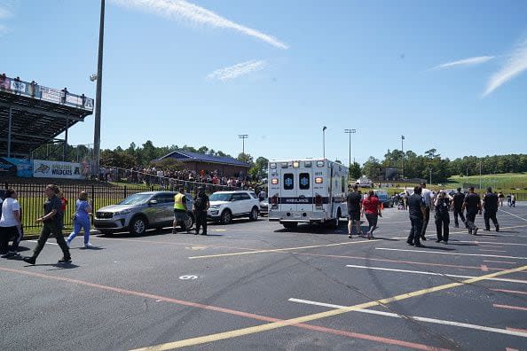 WINDER, GEORGIA - SEPTEMBER 4: Law enforcement and first responders work at the scene as students wait to be picked up by their parents after a shooting at Apalachee High School on September 4, 2024 in Winder, Georgia. Multiple fatalities and injuries have been reported and a suspect is in custody according to authorities. (Photo by Megan Varner/Getty Images)