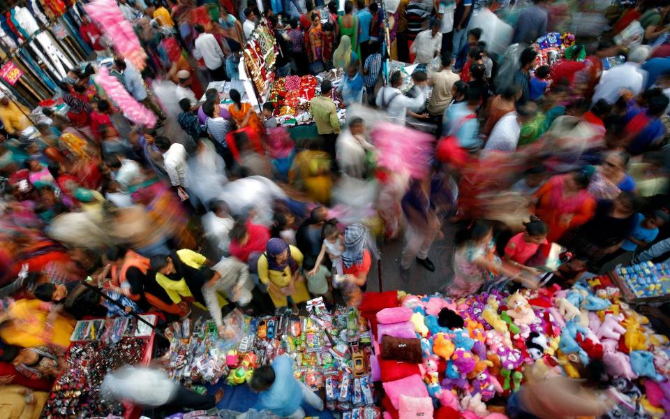 Shoppers at a busy market in Ahmedabad - Reuters