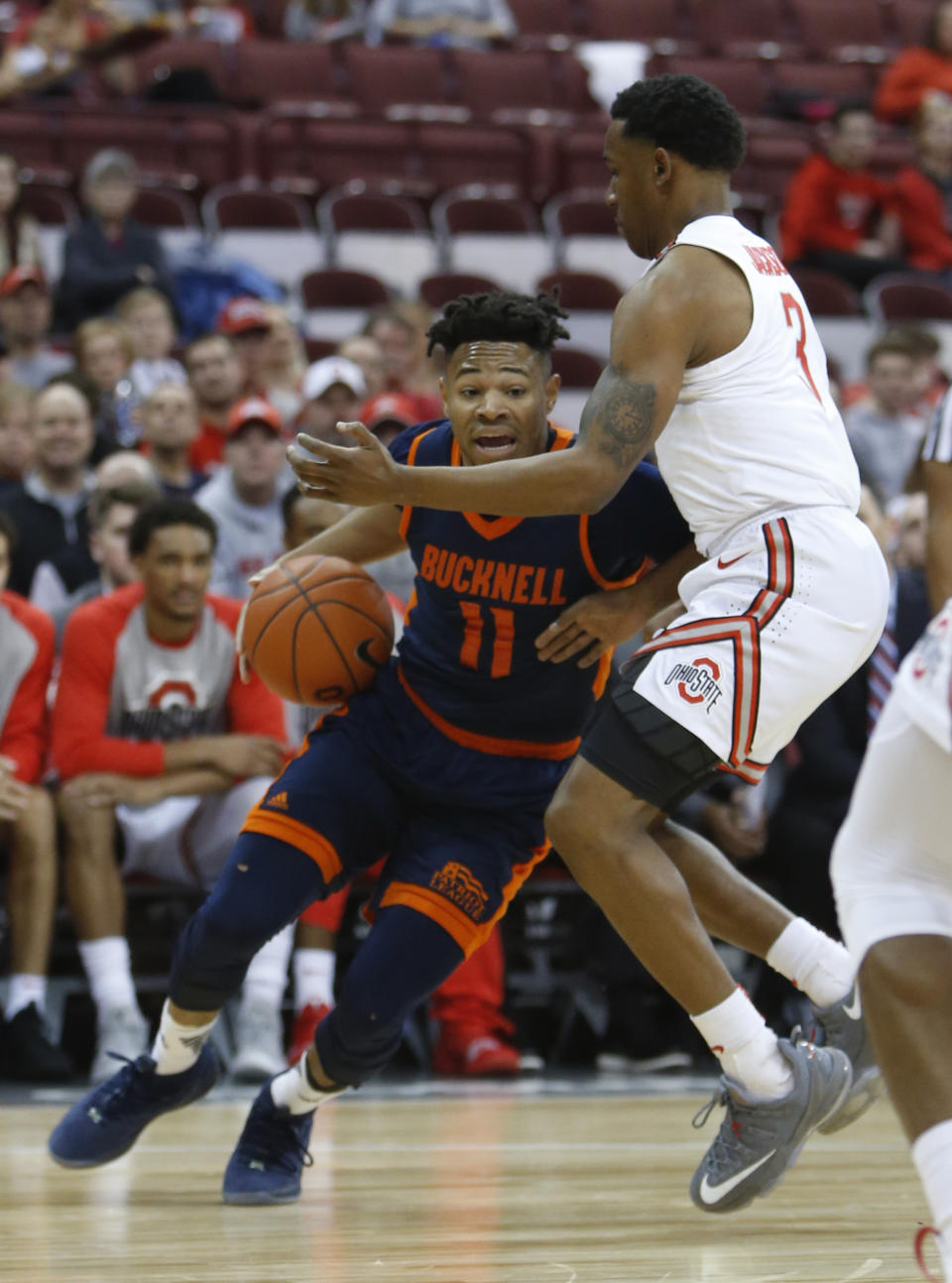 Bucknell's Avi Toomer, left, drives top the basket against Ohio State's C.J. Jackson during the first half of an NCAA college basketball game Saturday, Dec. 15, 2018, in Columbus, Ohio. (AP Photo/Jay LaPrete)