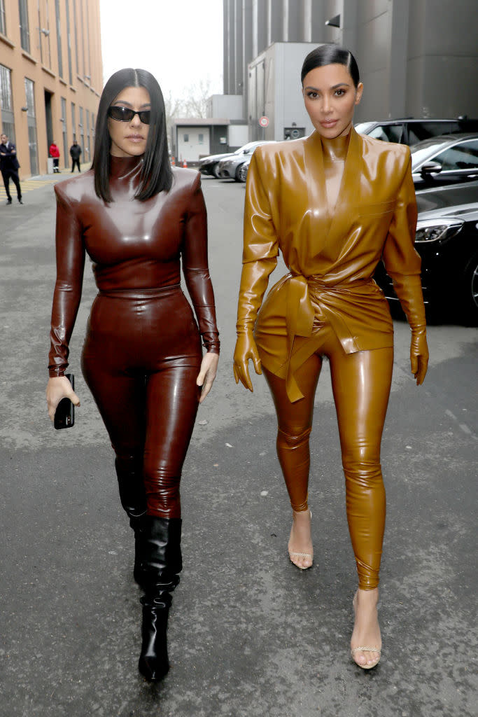 Kourtney and Kim Kardashian attend the Balenciaga show head to toe in Latex, pictured in March 2020. (Photo by Pierre Suu/Getty Images)