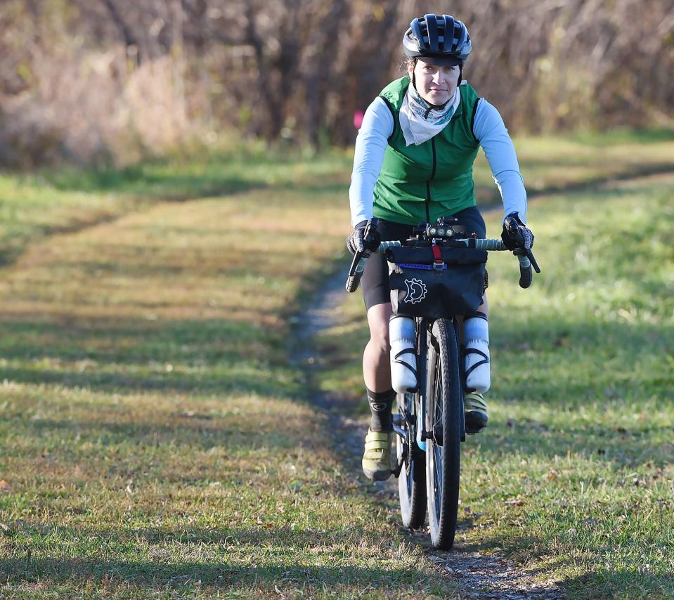 Maggie Livelsberger, 40, who competes in off-road trail biking, rides around Howard Eaton Reservoir in North East Township on Oct. 27, 2022. Livelsberger recently won a 487-mile race in Arkansas.