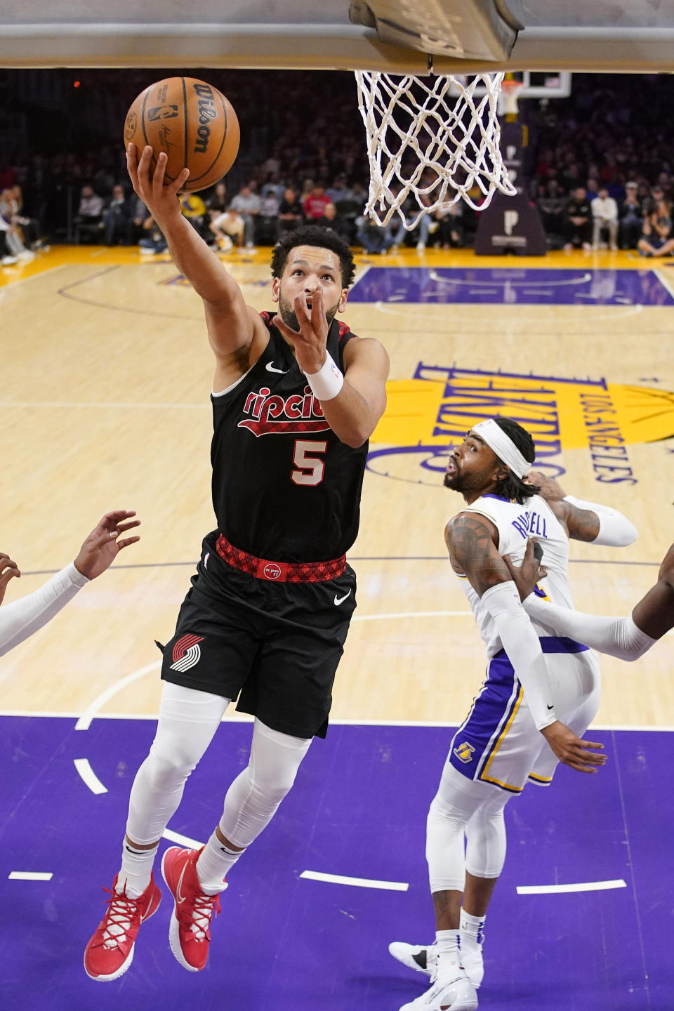 Portland Trail Blazers guard Skylar Mays, left, shoots as Los Angeles Lakers guard D'Angelo Russell defends during the first half of an NBA basketball game Sunday, Nov. 12, 2023, in Los Angeles. (AP Photo/Mark J. Terrill)