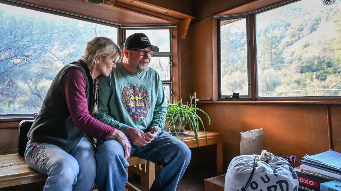 Longtime El Portal Trailer Park residents Neal and Nancy Dawson take a moment in their front room to take in the panoramic views of the surrounding canyon hills before moving out for good on Sunday, March 13, 2022.
