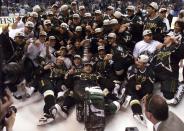 FILE - The Dallas Stars hockey team pose with the Stanley Cup after the Stars defeated the Buffalo Sabres 2-1 in triple overtime in Game 6 of the Stanley Cup finals in Buffalo, N.Y., Sunday, June 20,1999. No matter which team wins the Stanley Cup this year it will be a first this century. (AP Photo/Ryan Remiorz, File)