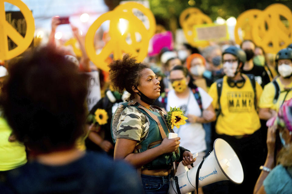 Black Lives Matter organizer Teal Lindseth, 21, leads protesters on Wednesday, July 22, 2020, in Portland, Ore. It was her 54th consecutive day leading the protest. (AP Photo/Noah Berger)