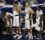 FILE - In this March 26, 2006, file photo, Connecticut players Rashad Anderson, left, Josh Boone (21), Ed Nelson (32), and Craig Austrie (24), watch the game from the sidelines during a loss to George Mason in the fourth round of the NCAA basketball tournament in Washington. George Mason beat Michigan State, North Carolina and Wichita State before taking down No. 1 seed Connecticut and its roster full of NBA talent 86-84 in overtime. They lost 73-58 to eventual national champion Florida in the semifinals. (AP Photo/Susan Walsh, File)