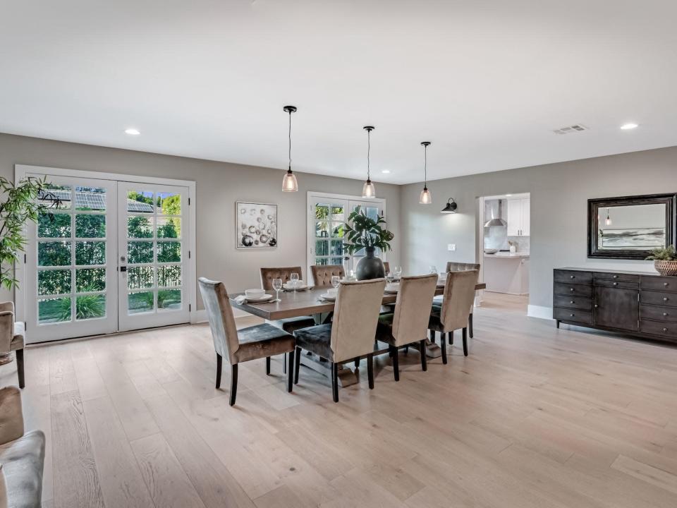 A dining room with french doors and a dining table.