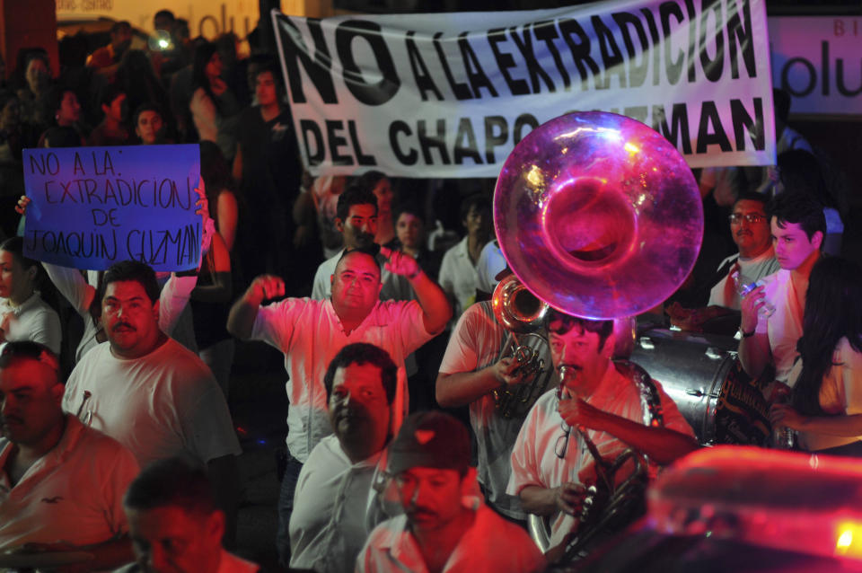 People play music and march in support of jailed top drug boss Joaquin Guzman Loera, "El Chapo" in the city of Culiacan, Mexico, Wednesday Feb. 26, 2014. Hundreds of people marched on the streets of Culiacan, the drug lord's bastion, demanding that Guzman be freed, before they briefly clashed with police who fired tear gas at them. The Sign says" No to the extradition of Chapo Guzman"(AP Photo/El Debate de Culiacan-Jonathan Telles)