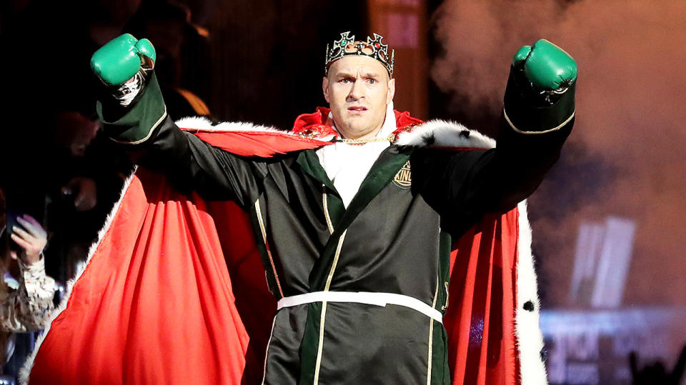 Tyson Fury dressed as a king and raising his hands as he enters the ring ahead of his fight with Deontay Wilder. (Getty Images)