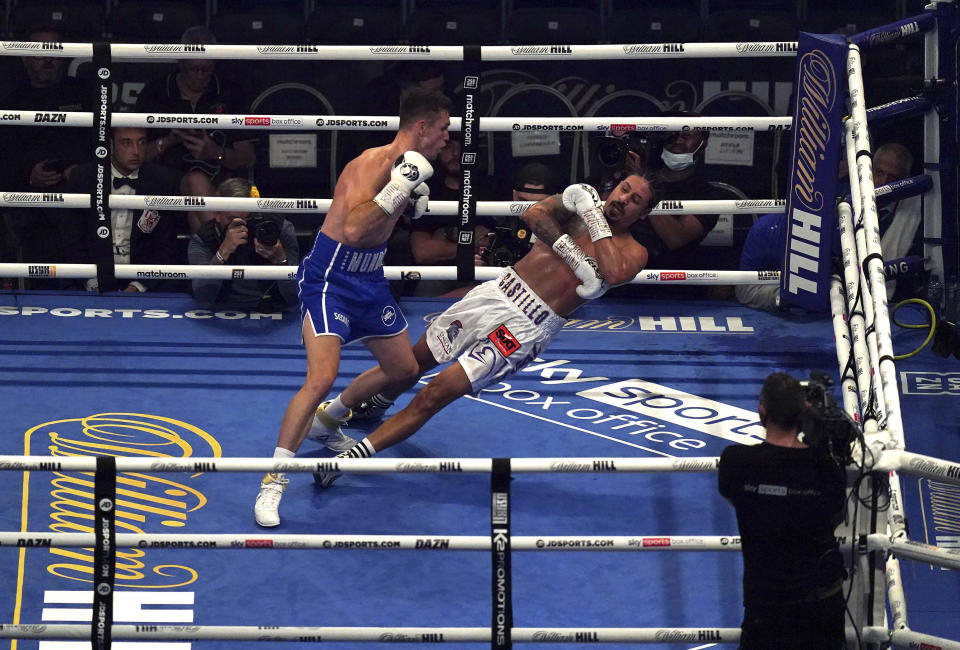 Britain's Callum Smith, left, knocks down Dominican Republic's Lenin Castillo during their Light-Heavyweight contest at the Tottenham Hotspur Stadium, in London, Saturday, Sept. 25, 2021. Castillo was taken to hospital after being carried out of the ring on a stretcher following a devastating knockout by British opponent Callum Smith. Event promoter Eddie Hearn says the 33-year-old Castillo was “responsive” after needing treatment by medical staff in the ring at Tottenham Hotspur Stadium in one of the fights on the undercard of the world heavyweight title bout between Anthony Joshua and Oleksandr Usyk. Castillo’s legs appeared to spasm after he hit the canvas and referee Bob Williams quickly called off the fight in the second round.(Nick Potts/PA via AP)