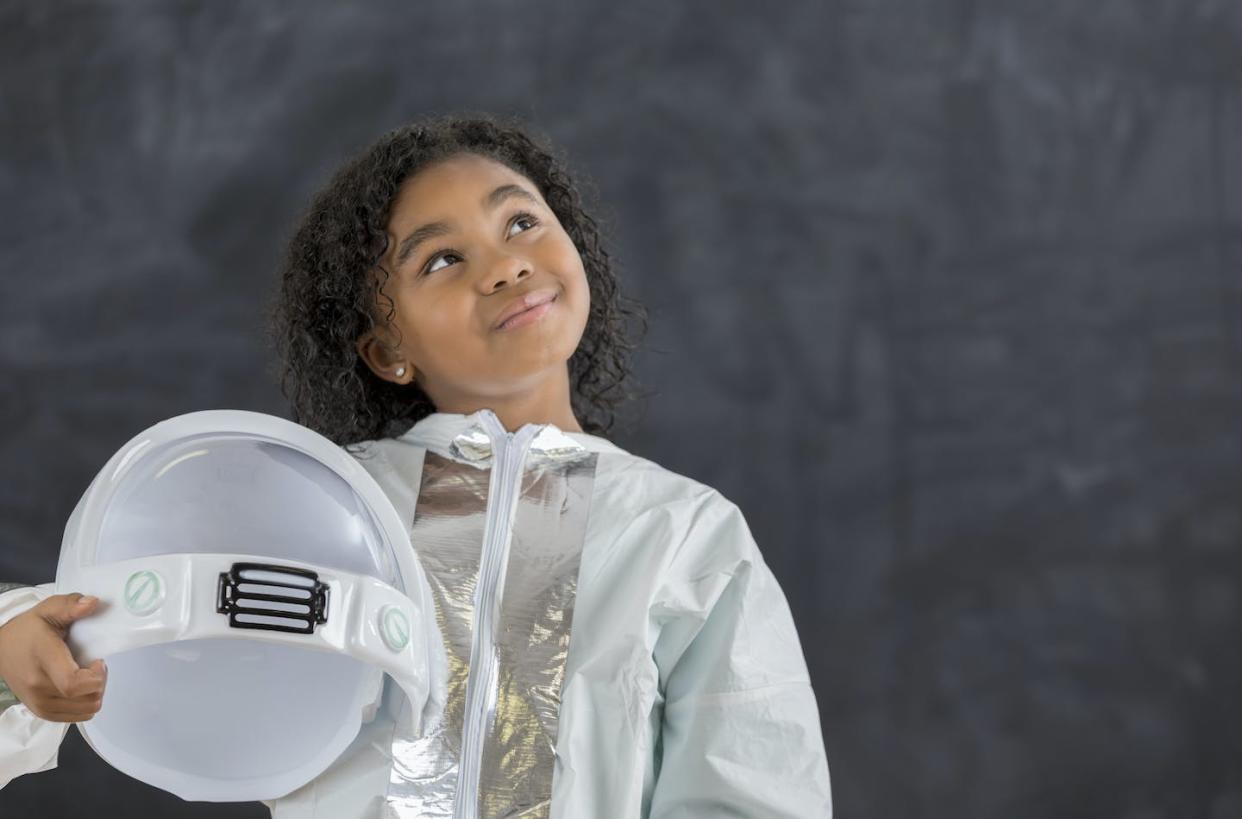 Children of color are hardly ever central characters in sci-fi books for kids. <a href="https://www.gettyimages.com/detail/photo/pretty-schoolgirl-in-astronaut-costume-royalty-free-image/647798810?phrase=black%20girl%20space%20future&adppopup=true" rel="nofollow noopener" target="_blank" data-ylk="slk:SDI Productions via Getty Images;elm:context_link;itc:0;sec:content-canvas" class="link ">SDI Productions via Getty Images</a>