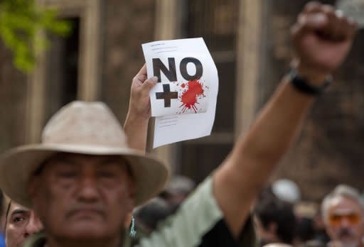 People protest against drug-related violence in Mexico City. Experts sought Thursday to identify the 59 bodies found in mass graves in northern Mexico, as officials came under pressure from rights groups to get its security crisis under control